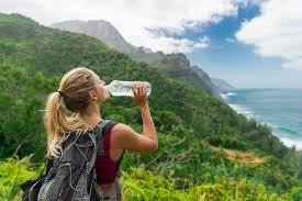 Woman drinking water during a healthy outdoor hike