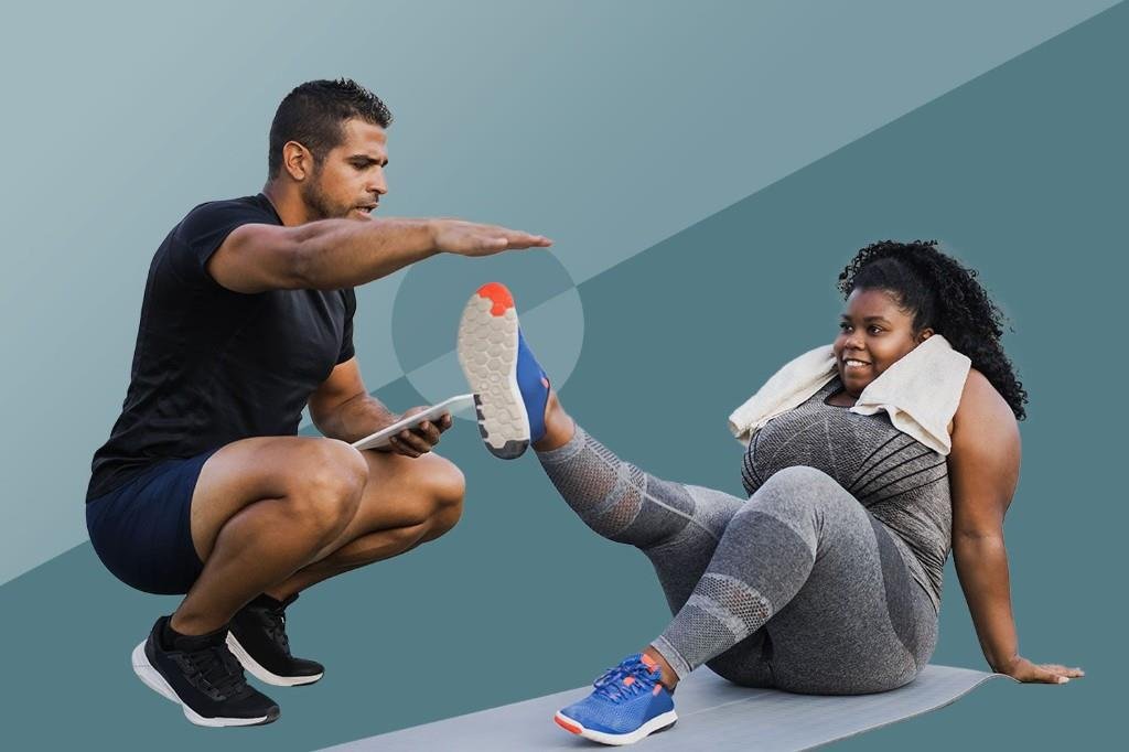 Personal trainer helping a client with a workout exercise